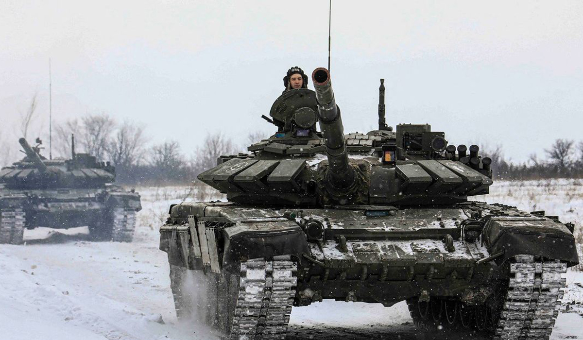 Russian servicemen drive tanks during military exercises